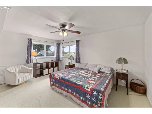a bedroom with a bed a chandelier and dresser