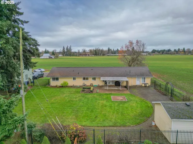 an aerial view of a house with garden space and ocean view