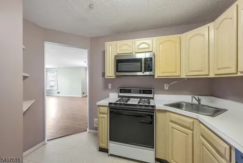 a kitchen with a sink and steel appliances