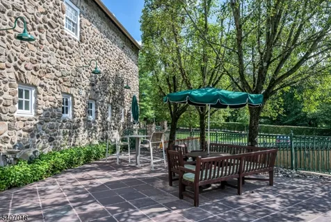 a view of a patio with a table and chairs