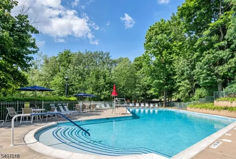 a view of a swimming pool with chairs