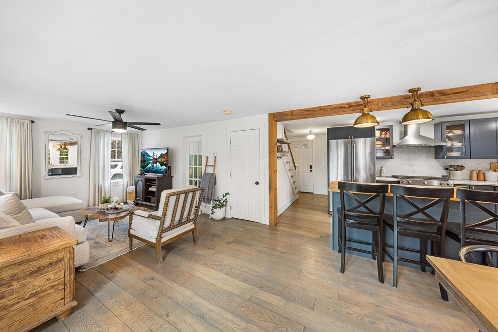 396 Hollis Road Lunenburg, MA 01462 - Photo 6 of 30 a living room with furniture and a dining table with kitchen view