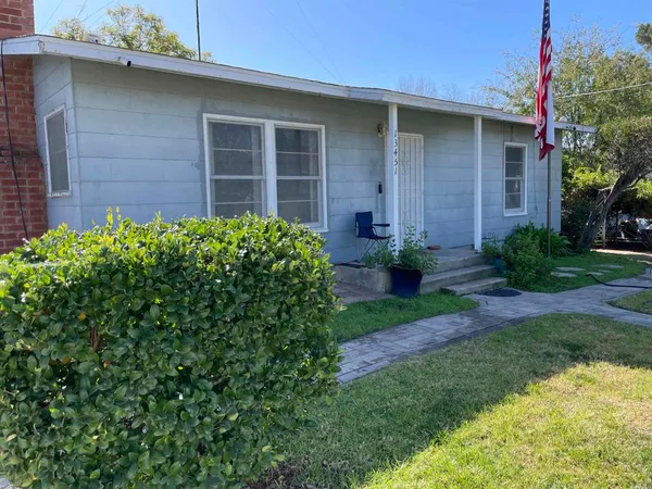 a view of a house with a yard and plants