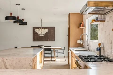 a kitchen with stainless steel appliances granite countertop a stove and a sink