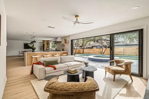 a living room with furniture and a floor to ceiling window