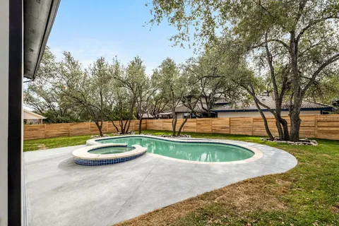a view of a swimming pool with a yard