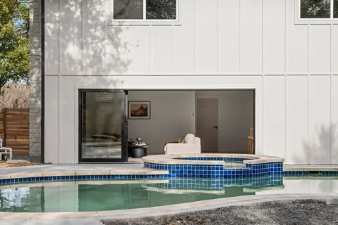 a living room with a bed and a table