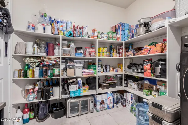 a large kitchen with cabinets chairs and a stove