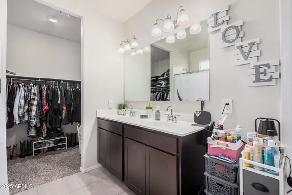 a bedroom with a bed a couch and a window