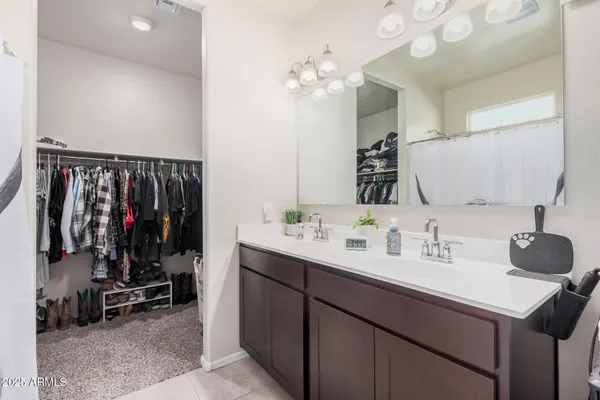 a bathroom with a sink mirror and vanity