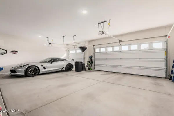 a view of a garage with furniture and a ceiling fan