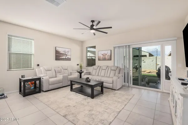 a living room with furniture a kitchen view and a fireplace
