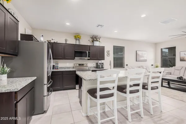 a kitchen with stainless steel appliances a stove sink microwave and cabinets