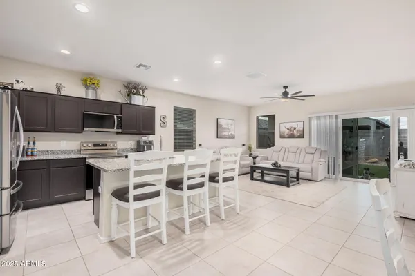 a kitchen with stainless steel appliances kitchen island granite countertop a sink and cabinets