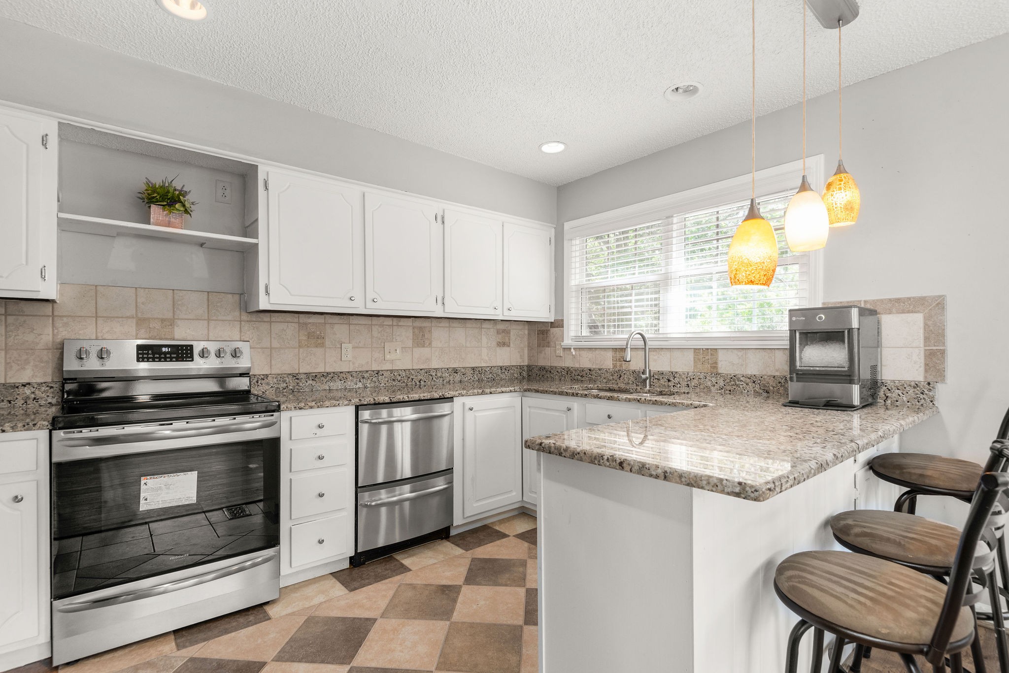 305 Cedarcliff Road Antioch, TN 37013 - Photo 13 of 32 a kitchen with stainless steel appliances granite countertop a stove a sink and a microwave