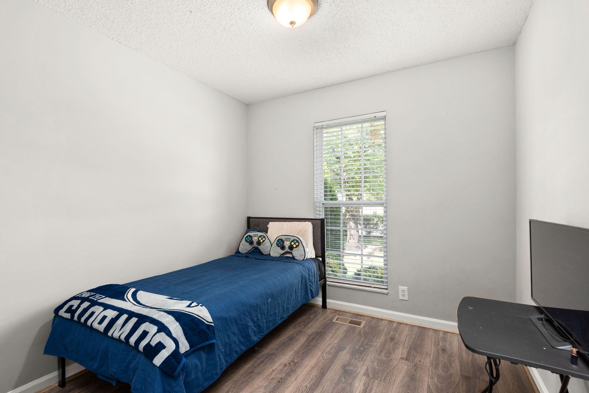 305 Cedarcliff Road Antioch, TN 37013 - Photo 21 of 32 a bedroom with a bed two lamps and a chair