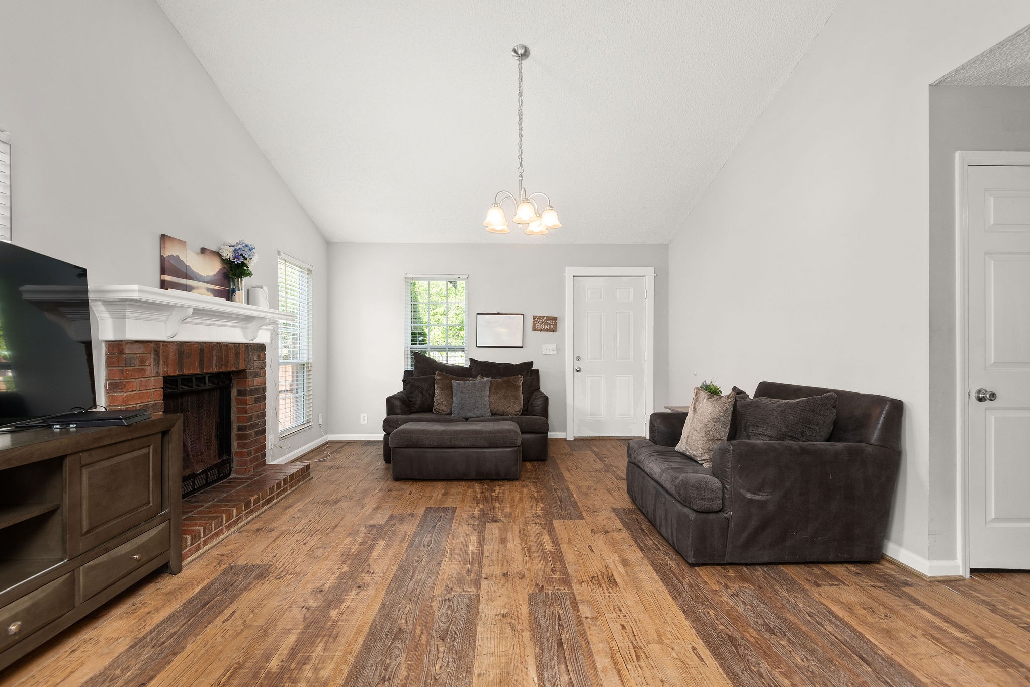 305 Cedarcliff Road Antioch, TN 37013 - Photo 6 of 32 a living room with furniture a flat screen tv and a fireplace