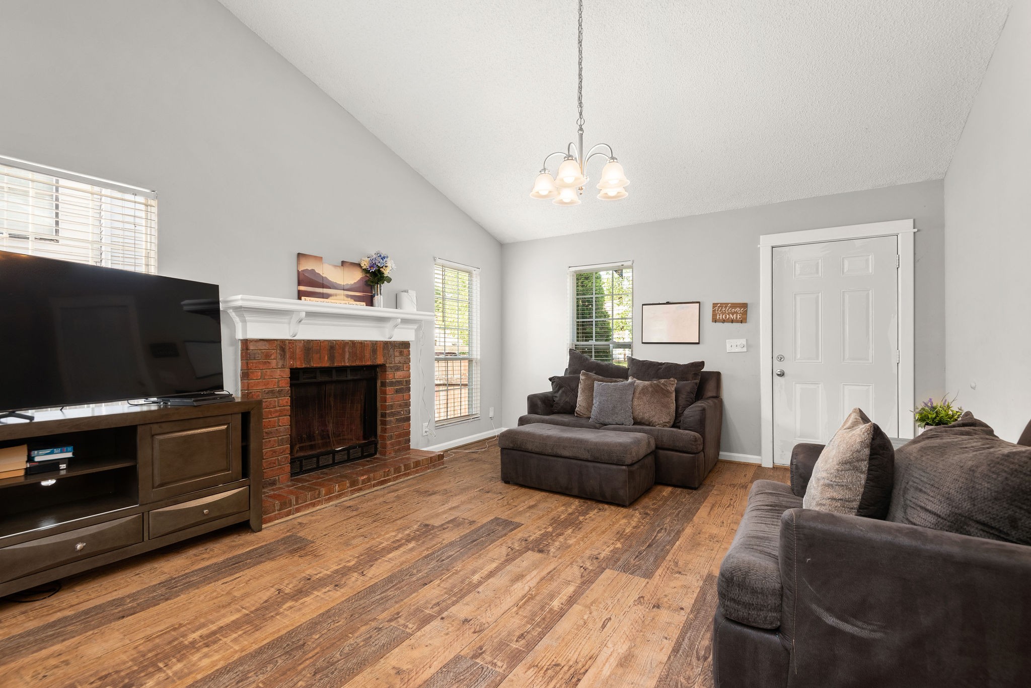 305 Cedarcliff Road Antioch, TN 37013 - Photo 7 of 32 a living room with furniture a flat screen tv and a fireplace