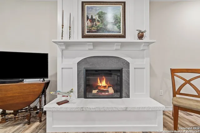 a living room with furniture and a fireplace