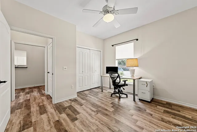 a view of a workspace with furniture and a window