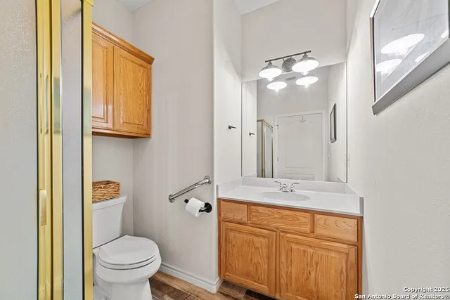 a bathroom with a sink a toilet and a mirror