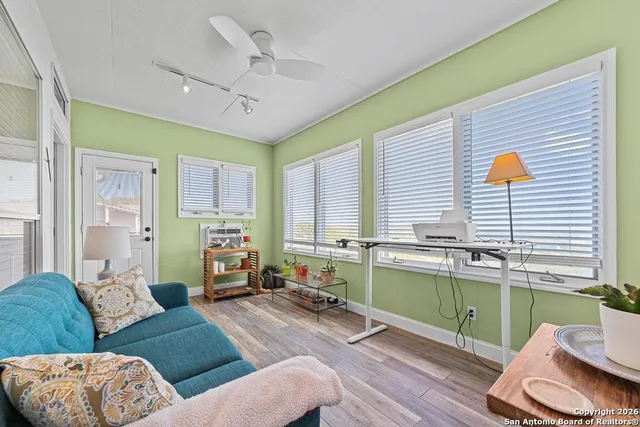a living room with furniture and a wooden floor