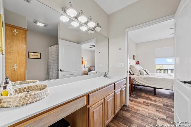 a en suite bathroom with a double vanity sink and a mirror