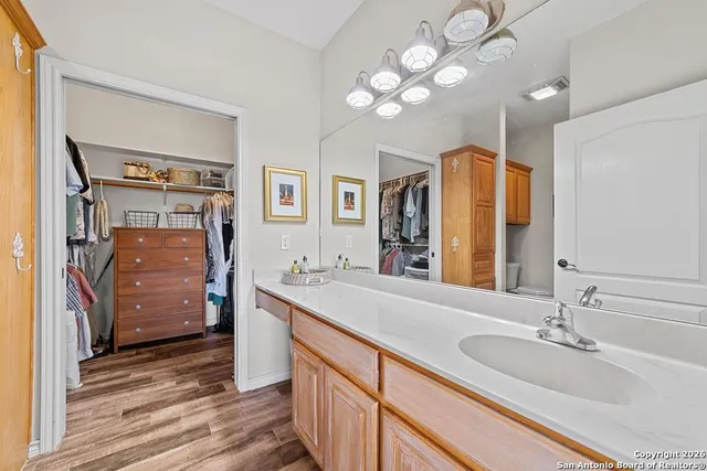 a bathroom with a double vanity sink and a mirror