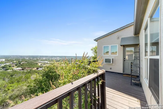 a view of a balcony with wooden floor and fence