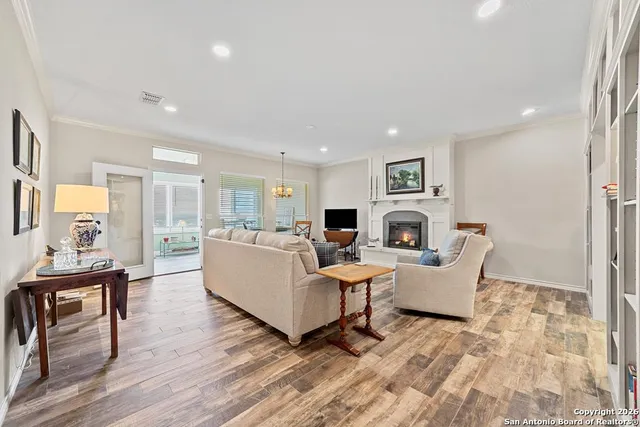a living room with fireplace furniture and a wooden floor