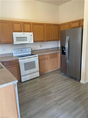 a kitchen with a stove a refrigerator and a sink