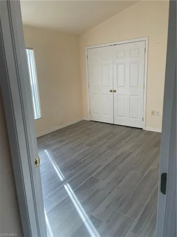 an empty room with wooden floor