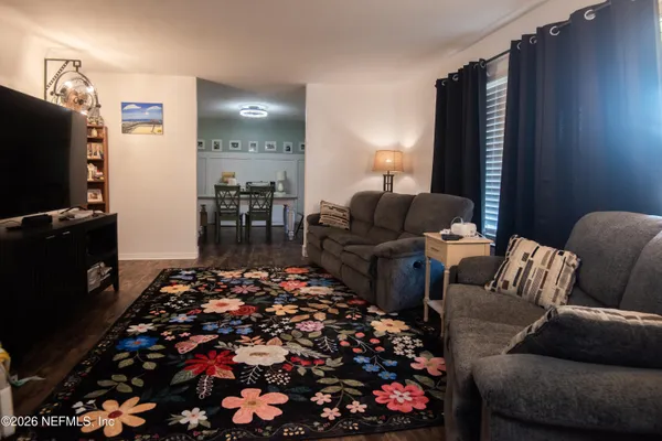 a living room with furniture and a flat screen tv