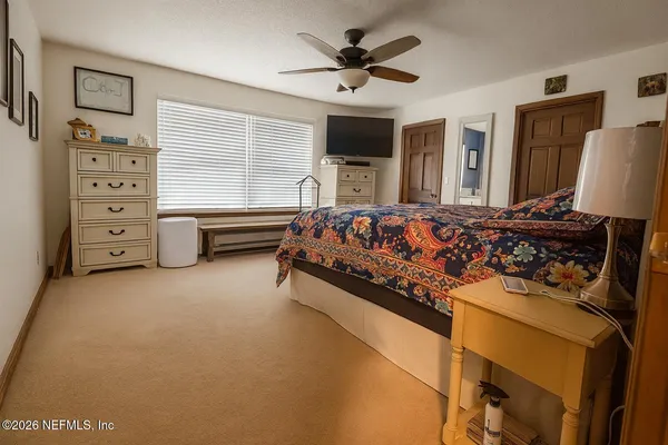 a bed room with a bed and a television