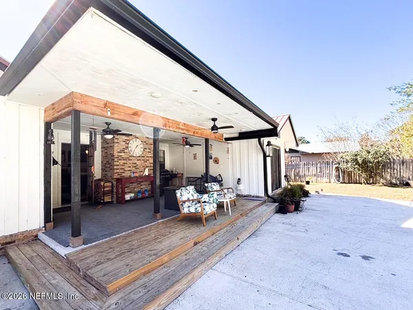 a bathroom with stainless steel appliances a sink and a large window
