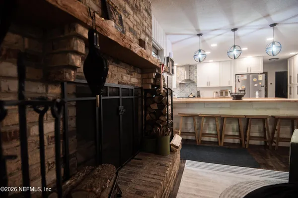 a large kitchen with a table and chairs