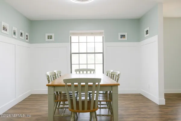 a view of a dining room with furniture and wooden floor