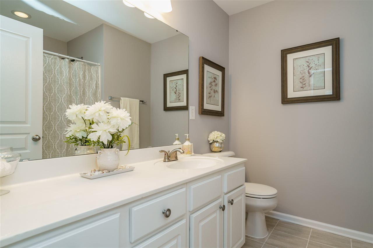 7675 Winners Edge Street Raleigh, NC 27617 - Photo 13 of 23 a bathroom with a sink mirror and toilet
