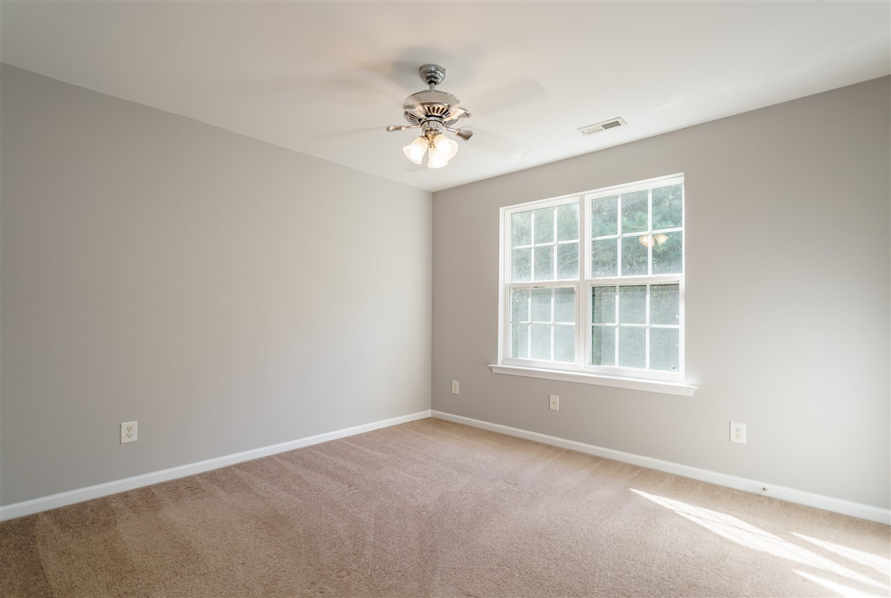 7675 Winners Edge Street Raleigh, NC 27617 - Photo 14 of 23 an empty room with a window and a chandelier