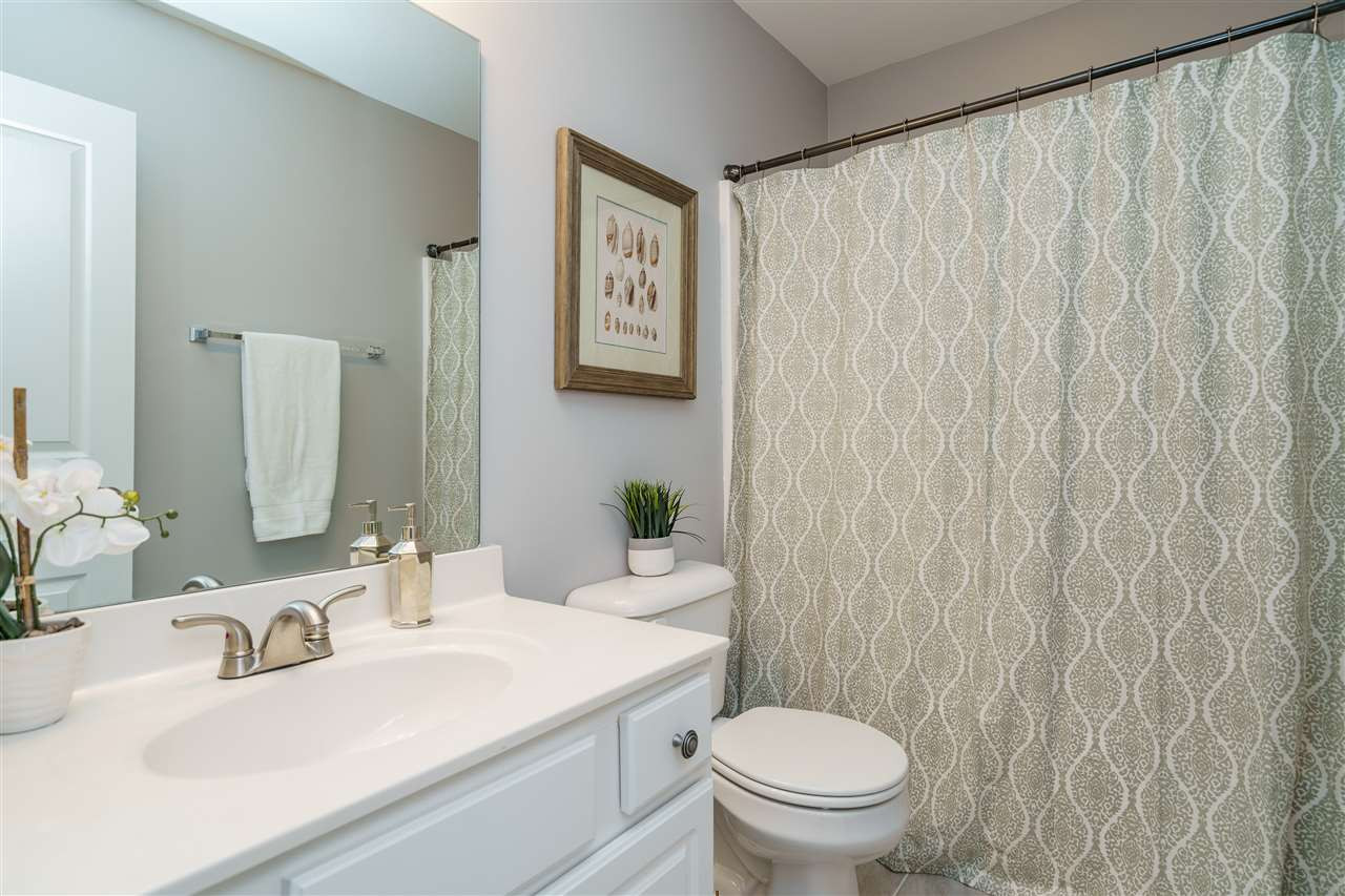7675 Winners Edge Street Raleigh, NC 27617 - Photo 15 of 23 a bathroom with a sink a toilet and a mirror