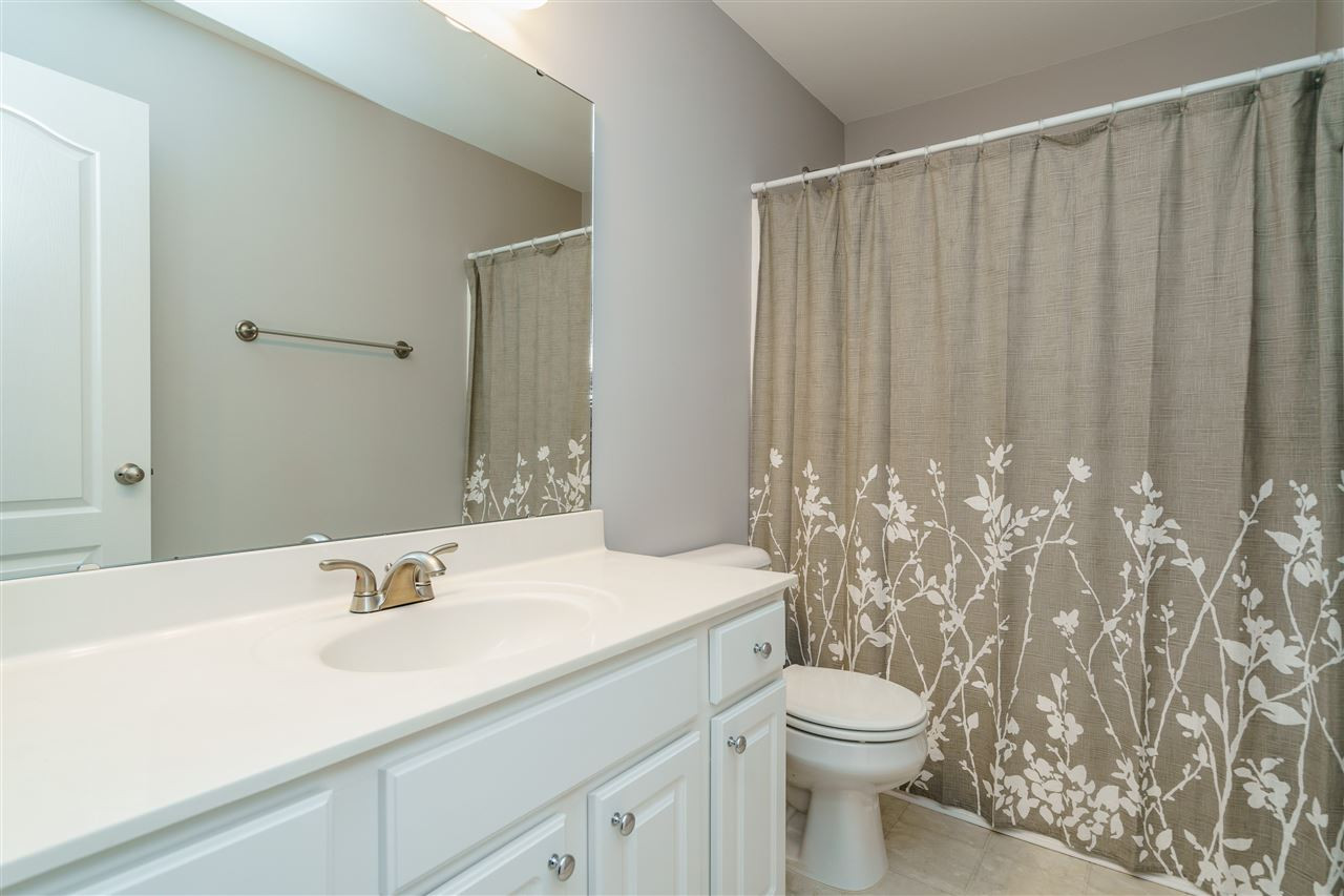 7675 Winners Edge Street Raleigh, NC 27617 - Photo 19 of 23 a bathroom with a sink a toilet and shower