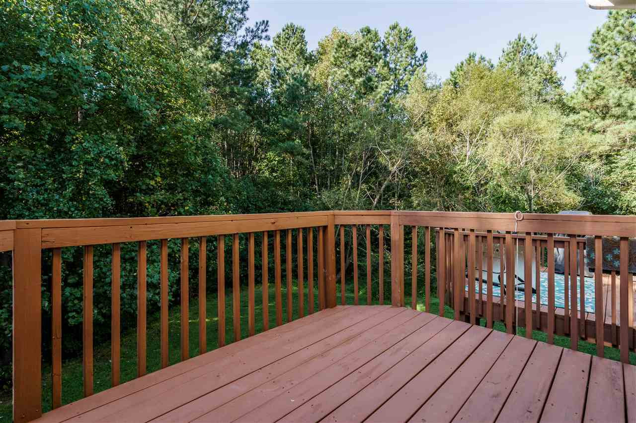 7675 Winners Edge Street Raleigh, NC 27617 - Photo 21 of 23 a balcony with wooden floor and trees in the back