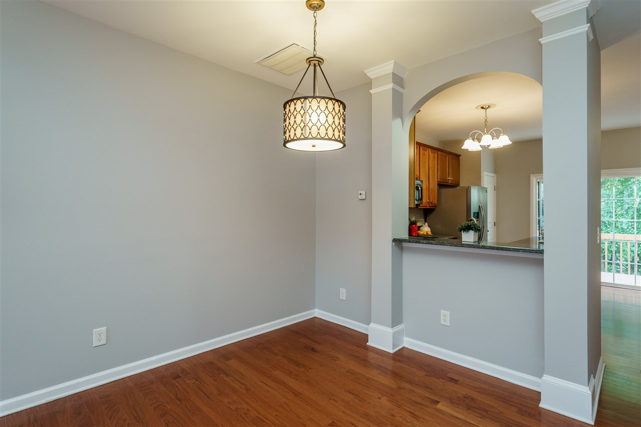 7675 Winners Edge Street Raleigh, NC 27617 - Photo 5 of 23 an empty room with wooden floor and windows