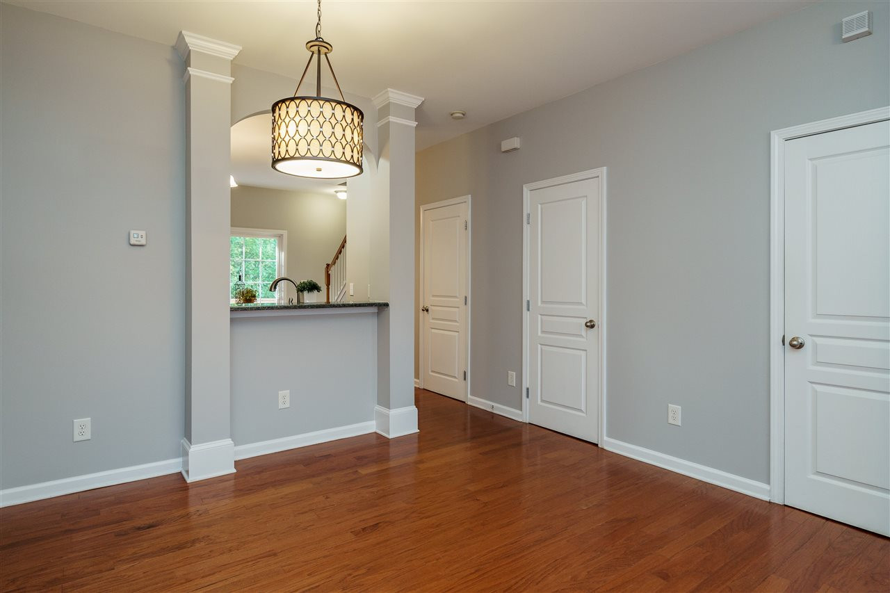 7675 Winners Edge Street Raleigh, NC 27617 - Photo 6 of 23 an empty room with wooden floor and mirror