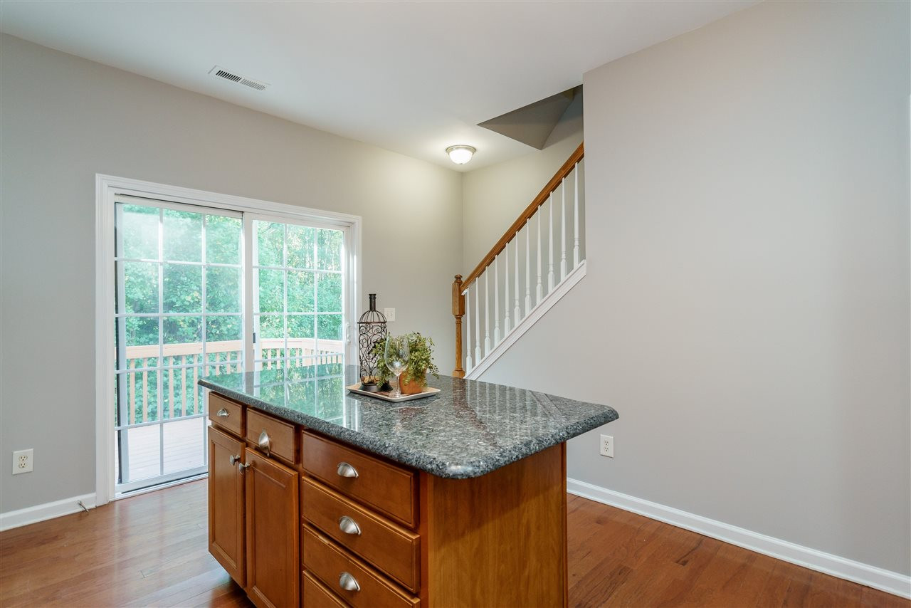 7675 Winners Edge Street Raleigh, NC 27617 - Photo 9 of 23 a kitchen that has a sink and a table in it