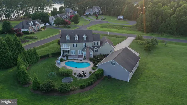 an aerial view of a house with outdoor space pool seating area and yard