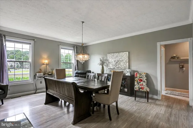 a large kitchen with stainless steel appliances kitchen island granite countertop a refrigerator and a sink