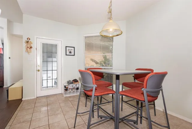 a dining room with furniture and window