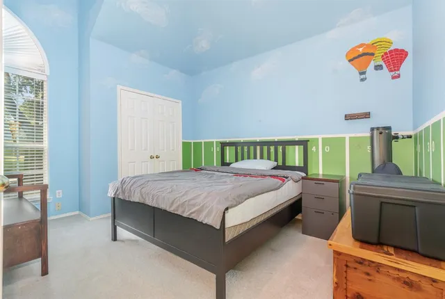 a bedroom with a bed and a dresser