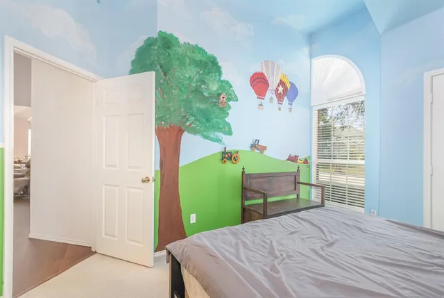 a bedroom with a bed and a window